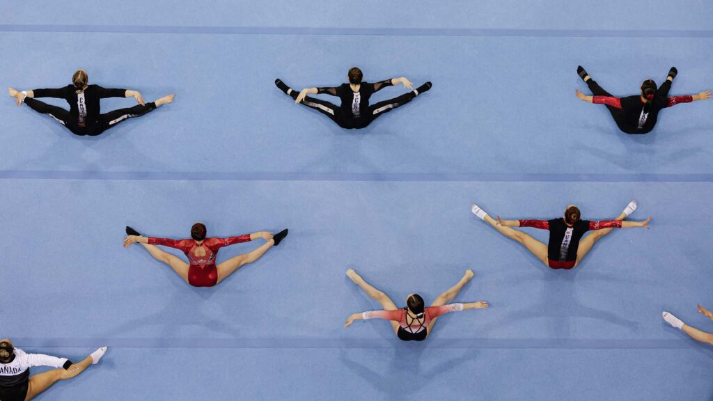 aerial shot of gymnasts stretching on the floor