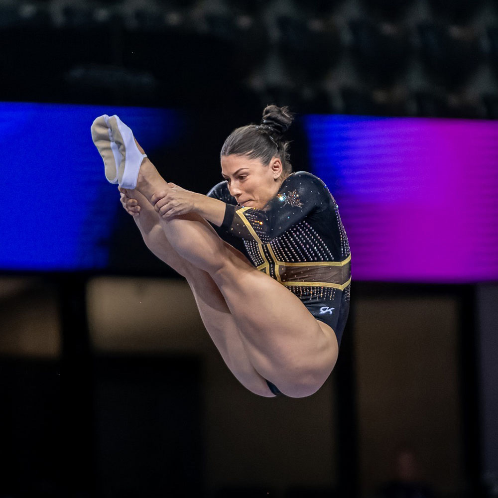 Gymnast Sophiane Methot shown in a pike position