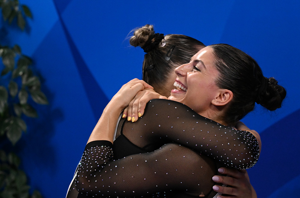 Two female gymnasts embrace