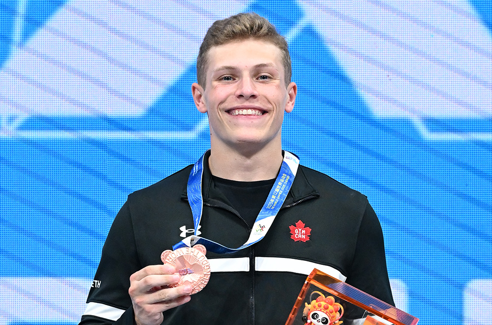 Male athlete smiling with medal